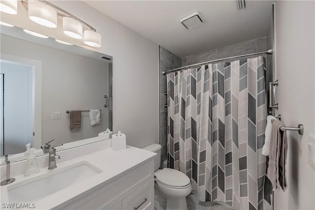 bathroom featuring toilet, vanity, and curtained shower