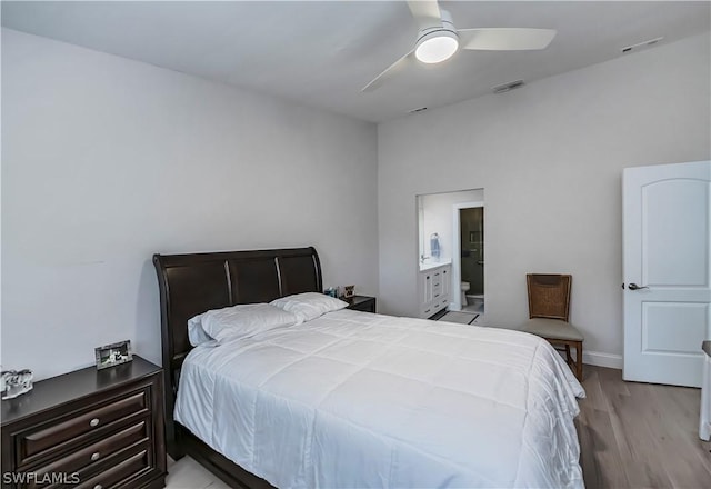 bedroom with ensuite bath, ceiling fan, and light wood-type flooring