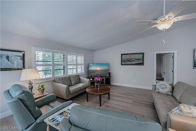 living room featuring ceiling fan, vaulted ceiling, and hardwood / wood-style floors