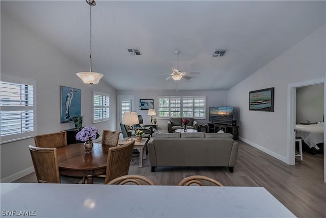 living room with lofted ceiling, wood-type flooring, and ceiling fan