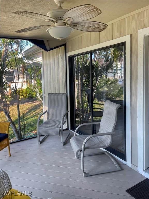 sunroom / solarium featuring ceiling fan