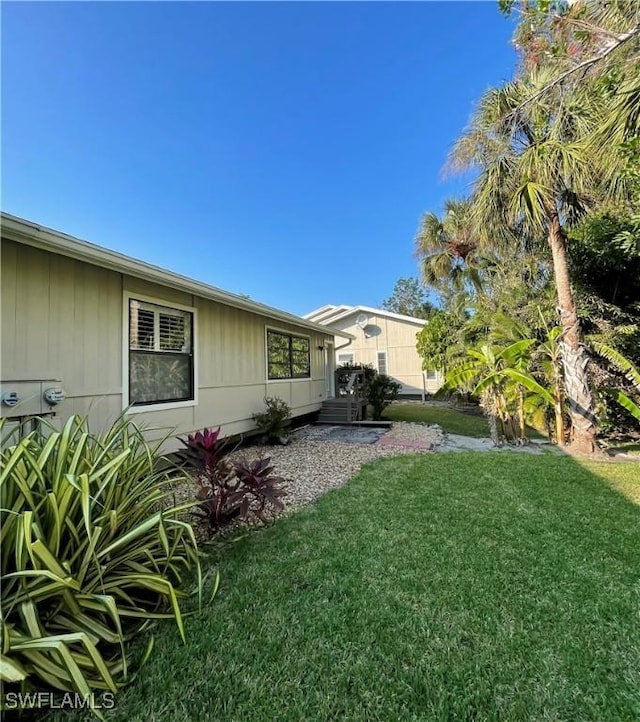 view of side of property featuring a yard