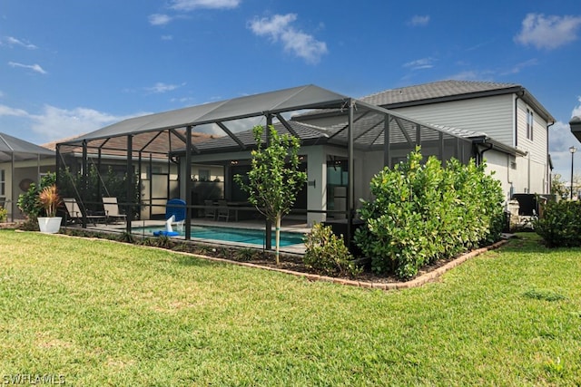 rear view of property with a lawn, a patio, and glass enclosure