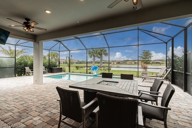 exterior space with a patio, ceiling fan, and glass enclosure