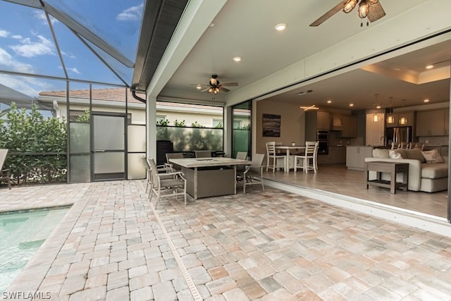 view of patio with an outdoor living space, a pool, ceiling fan, and glass enclosure