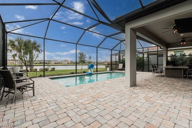 view of swimming pool featuring a patio, a lanai, and ceiling fan