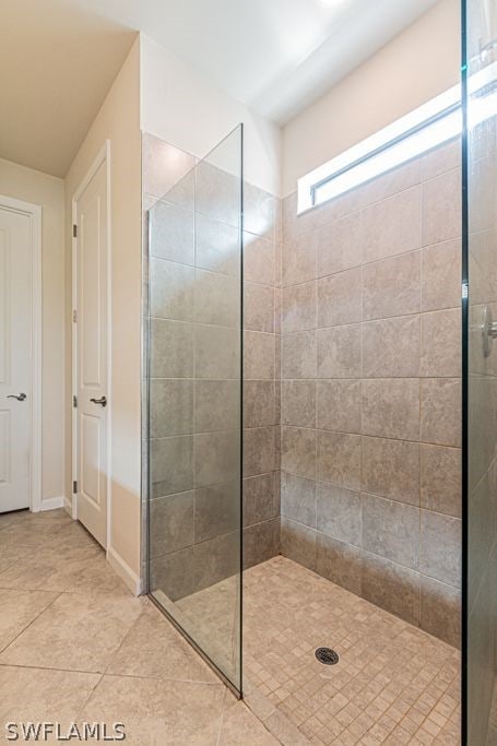 bathroom with tile floors and tiled shower