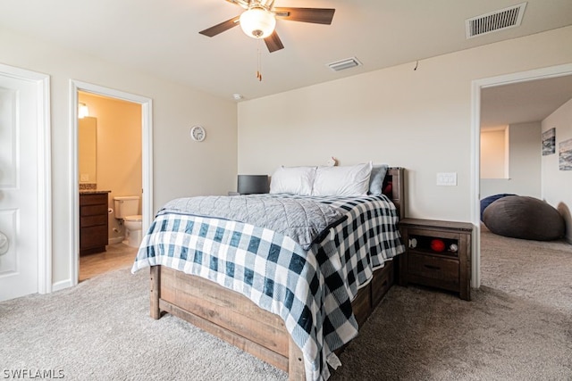 carpeted bedroom featuring connected bathroom and ceiling fan