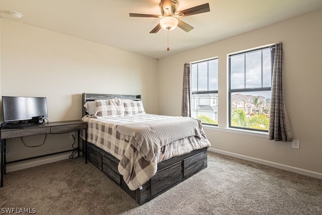 bedroom featuring ceiling fan and dark carpet