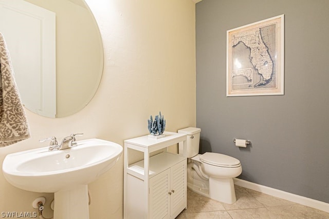 bathroom with tile floors and toilet