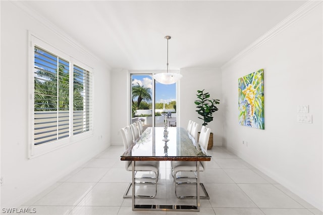 tiled dining area featuring crown molding