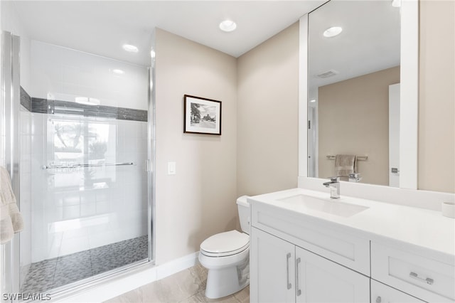 bathroom with toilet, vanity, tile patterned flooring, and a shower with shower door