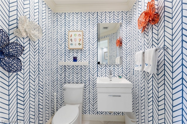 bathroom featuring ornamental molding, vanity, and toilet