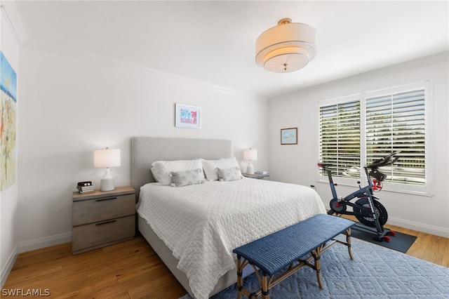 bedroom featuring hardwood / wood-style floors and ornamental molding