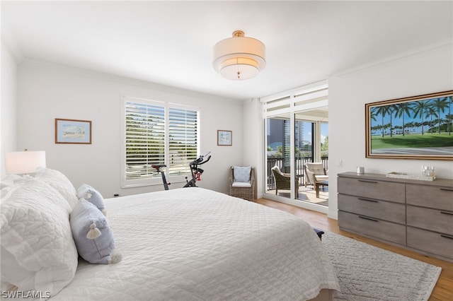 bedroom featuring access to exterior, light wood-type flooring, and crown molding