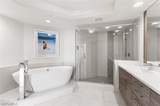 bathroom featuring independent shower and bath, vanity, and tile patterned flooring