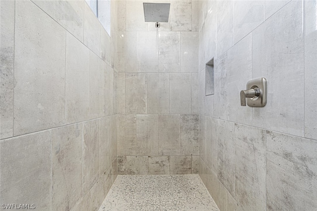 bathroom with tiled shower