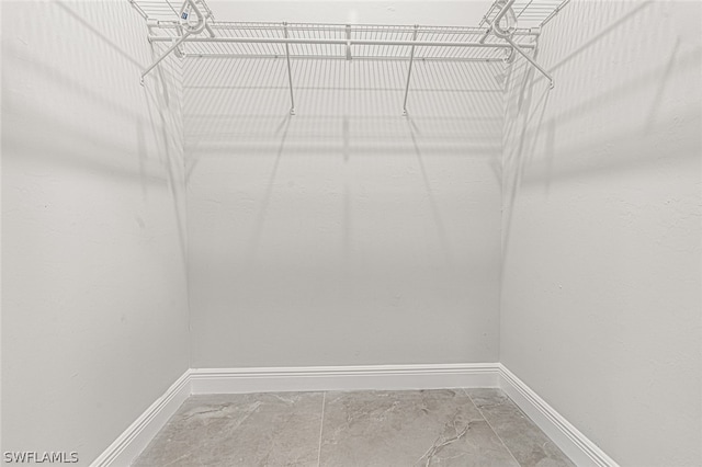 spacious closet with tile flooring