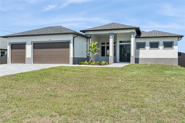 prairie-style house featuring a front yard and a garage