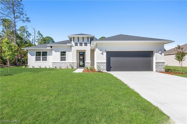 prairie-style home featuring a front lawn and a garage