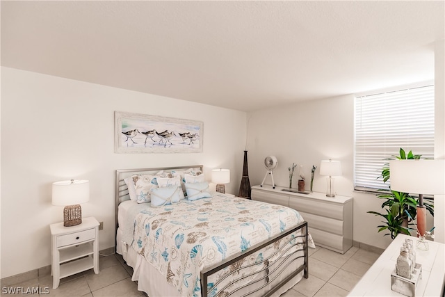 bedroom featuring light tile floors