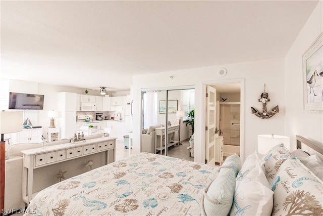 tiled bedroom with ensuite bathroom, a closet, and sink