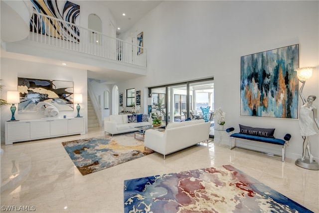 tiled living room featuring a towering ceiling