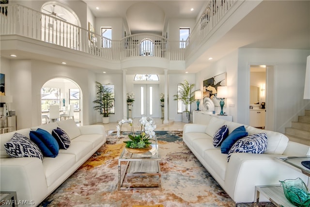 living room featuring tile flooring and a high ceiling