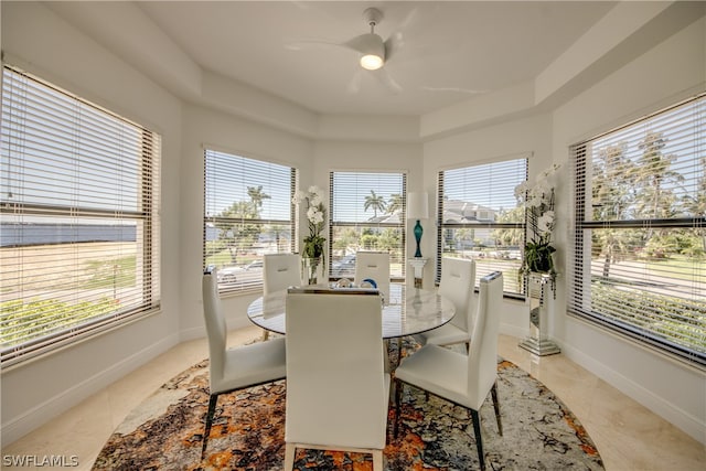 dining space with light tile floors, ceiling fan, and a wealth of natural light