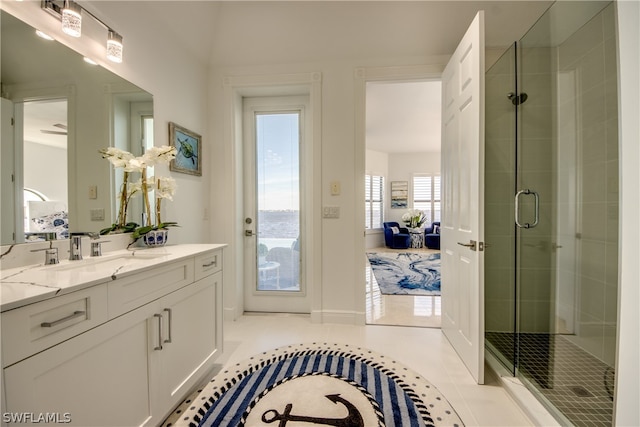 bathroom featuring tile flooring, walk in shower, and vanity