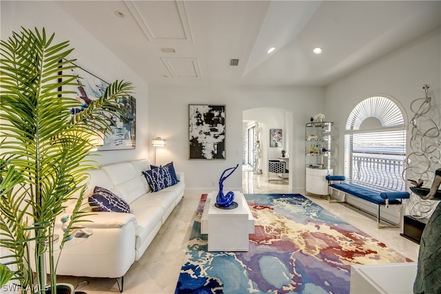 tiled living room with lofted ceiling