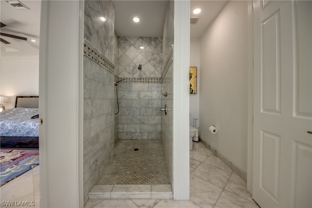 bathroom featuring toilet, ceiling fan, ornamental molding, tile floors, and a tile shower