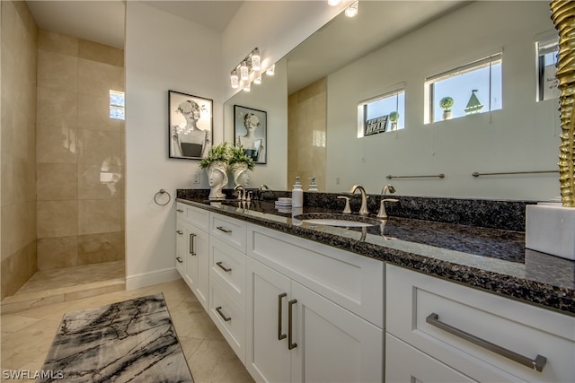 bathroom featuring tile floors and dual bowl vanity