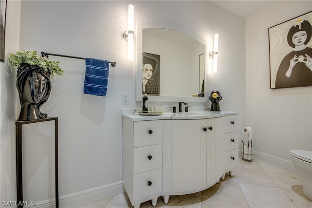 bathroom with toilet, tile floors, and vanity