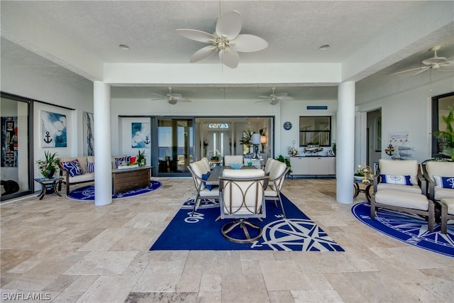 tiled dining space featuring french doors, a textured ceiling, and ceiling fan