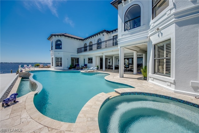 view of pool featuring a patio area and an in ground hot tub