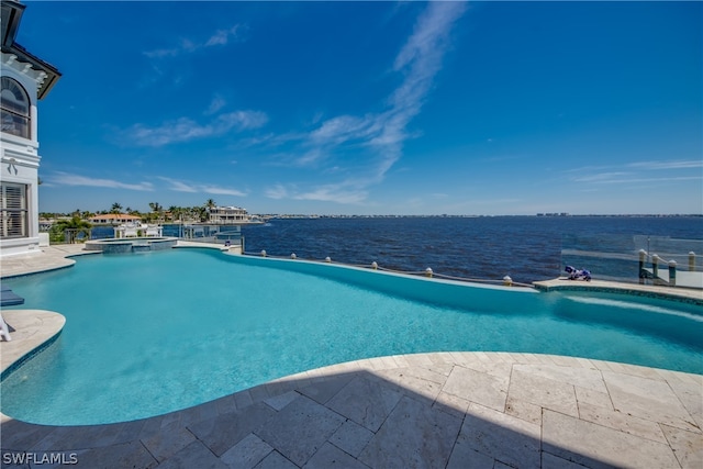 view of swimming pool with a water view and a patio