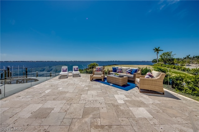 view of patio featuring a water view and outdoor lounge area