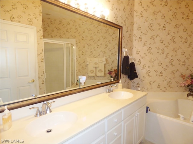 bathroom featuring vanity and independent shower and bath