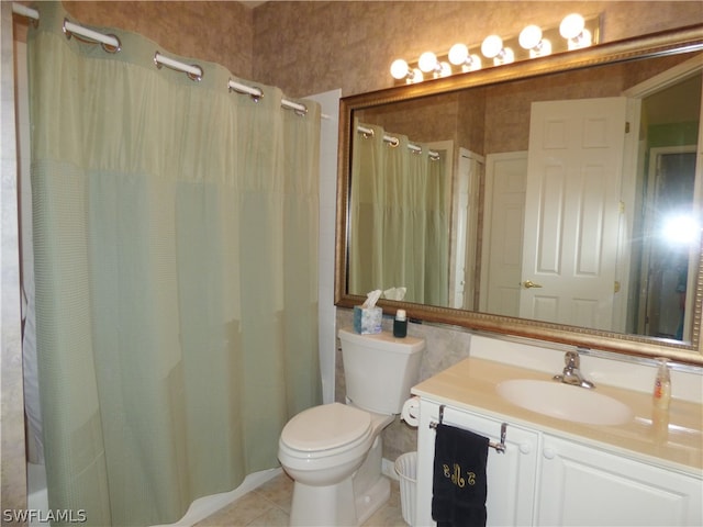 bathroom with tile patterned flooring, vanity, and toilet