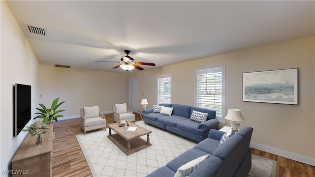 living room featuring ceiling fan and light hardwood / wood-style flooring