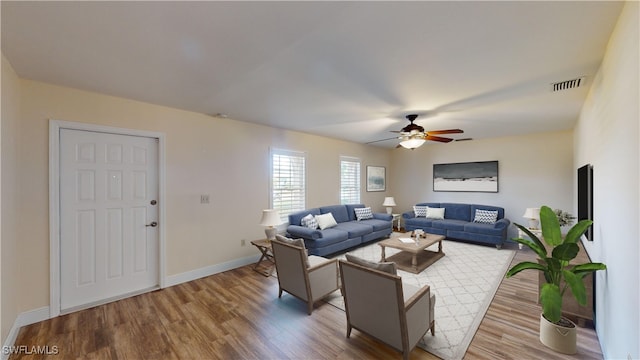 living room featuring hardwood / wood-style flooring and ceiling fan