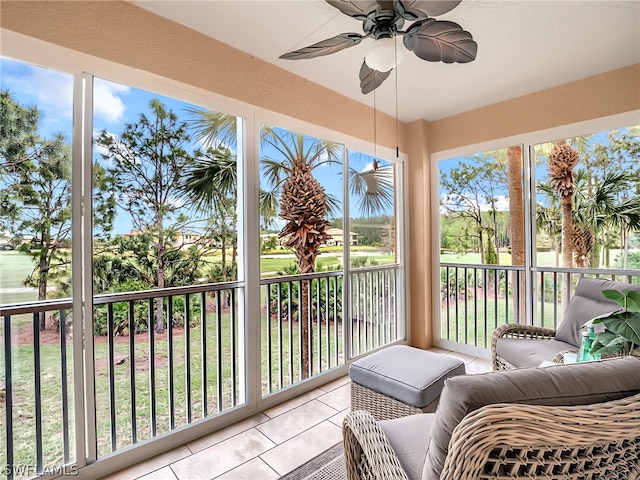 sunroom / solarium featuring ceiling fan