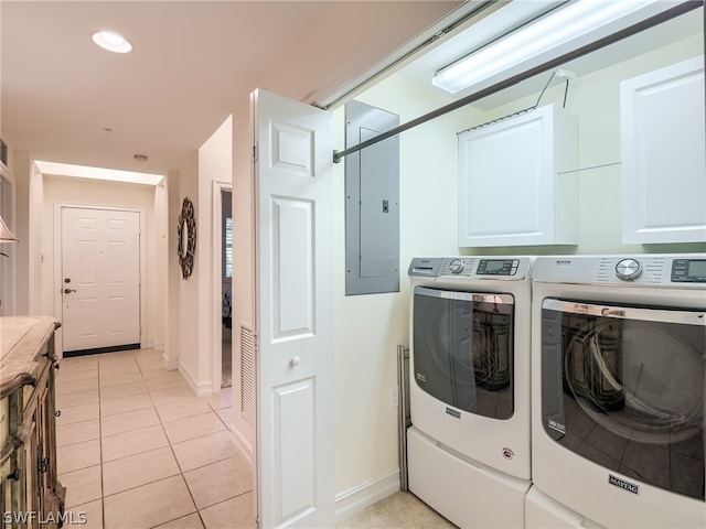 laundry area with washer and dryer, cabinets, light tile patterned floors, and electric panel