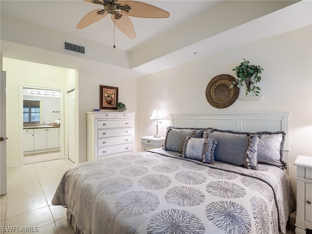 tiled bedroom featuring ceiling fan and ensuite bath