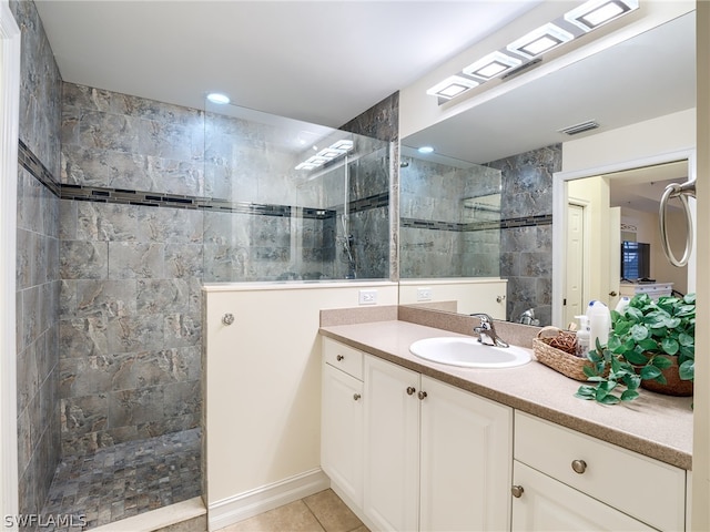 bathroom featuring tile patterned floors, a shower, and vanity