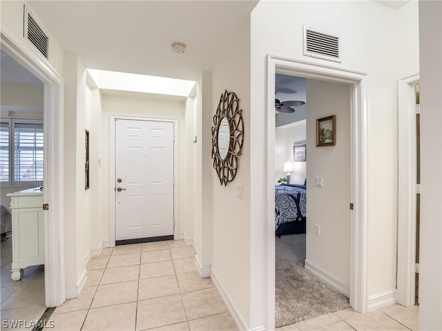 hall with light tile patterned flooring