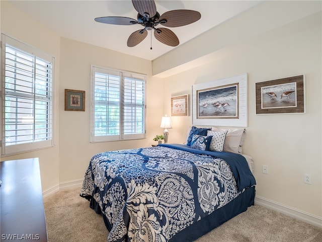 bedroom with ceiling fan and light colored carpet