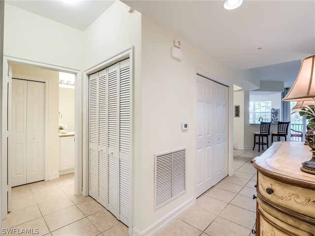 hall with light tile patterned floors