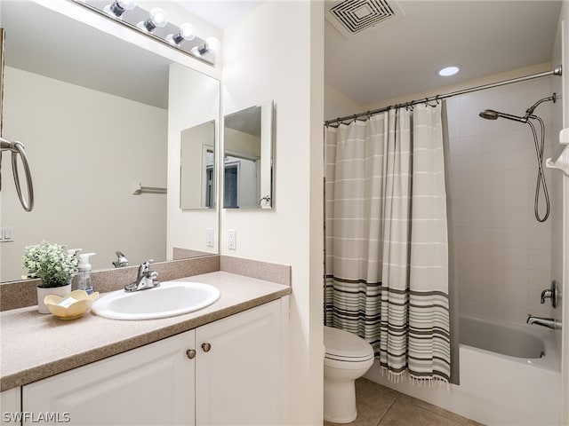 full bathroom with tile patterned flooring, shower / bath combination with curtain, vanity, and toilet